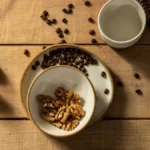 Overhead view of coffee cupping bowls and a Kalita Wave dripper on a dark surface.