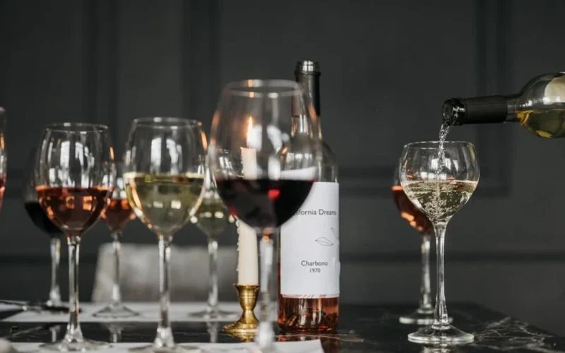 A set dining table with wine glasses and small plates at a coastal cafe.