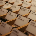 Assorted loose leaf tea varieties including dark pu'er and green oolong on a stone surface.