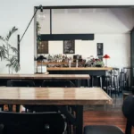 Sunny modern coffee shop interior with wooden tables and large windows in Orlando Florida.