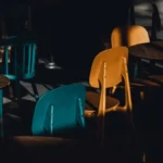 A sunlit corner of a local cafe with wooden tables and comfortable seating.
