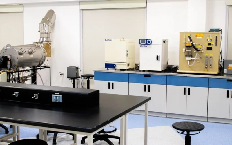 A high-tech coffee research laboratory with specialized brewing equipment and scientific glassware on clean laboratory c