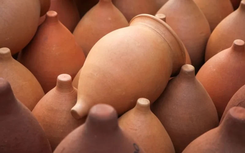 Close-up of the textured surface of an ancient terracotta clay wine vessel.