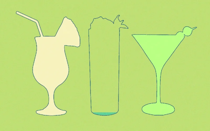 A sophisticated nonalcoholic cocktail with rosemary and citrus on a dark marble bar surface.